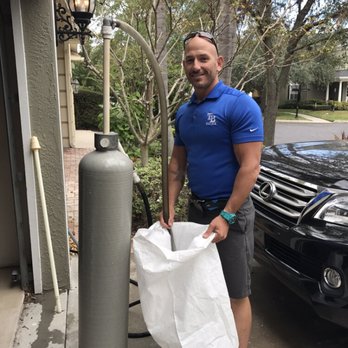 Dave carrying softener salt to a customer system