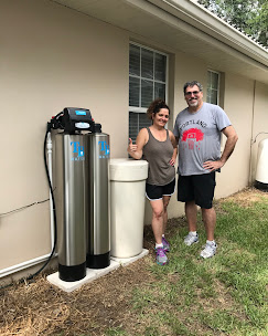 Homeowners beside their TB Water install outside their house