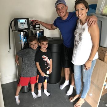 Family of four next to their TB Water whole-home system