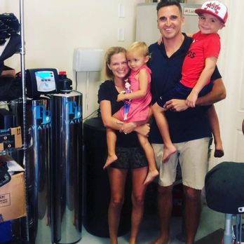 Dad and kids with their new TB Water system